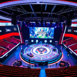 **Prompt:** A bustling, vibrant esports arena in a city like Madrid or Mexico City, filled with a diverse and passionate crowd, cheering enthusiastically. The central focus is a massive, brilliantly lit stage where professional League of Legends players are intensely competing. A giant screen above them displays a climactic in-game moment, rendered with high-fidelity graphics. The overall scene should convey the electrifying atmosphere, global scale, and the high production value of a major esports event, subtly featuring corporate sponsorship logos in the background to indicate economic impact.